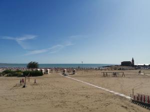 a group of people standing on a beach at Hotel Sara in Caorle