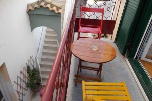 a table and chairs sitting on the side of a balcony at Square 's House in Lefkada +15 photos