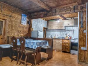 a kitchen with a table and chairs in a room at Vikendica Vlahović in Kolašin