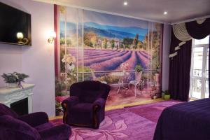 a bedroom with a wall mural of a vineyard at Apartments Provence in Chernivtsi