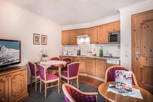 a kitchen with a table and chairs and a television at Appartement Sport Steger in Saalbach-Hinterglemm