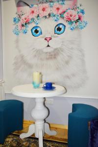 a cat with a flower crown on its head with a candle at Apartments Provence in Chernivtsi