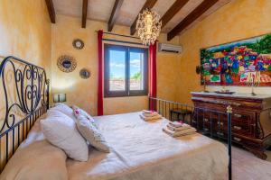 a bedroom with a bed and a painting on the wall at Casa Baix in Sineu +20 photos