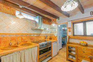 a kitchen with two sinks and a stove at Casa Baix in Sineu