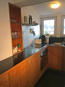 a kitchen with a counter and a refrigerator at Studio Emilie in Detmold