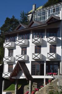 a white building with balconies on the side of it at MANUDI Glenfallsedge Rest in Nuwara Eliya