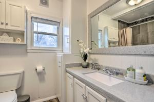 a bathroom with a sink and a mirror at Walkable and Updated Nevada Home Family Friendly! in Nevada
