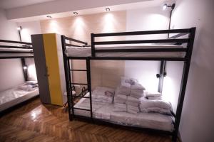 two bunk beds in a room with towels at Hostel Evropa in Nikšić