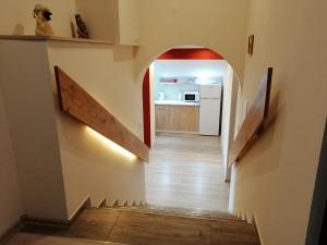 a hallway with an archway leading to a kitchen at Apartament TARA in Solina