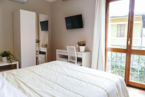 Postel nebo postele na pokoji v ubytování Gialel Pisa Guest House