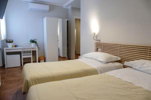 เตียงในห้องที่ Gialel Pisa Guest House