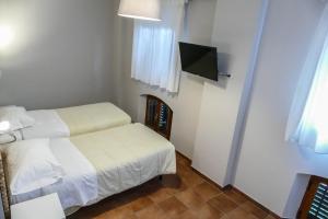 Postel nebo postele na pokoji v ubytování Gialel Pisa Guest House