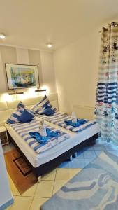 a bedroom with two beds with blue and white pillows at Willa Cyklada, grill, śniadania, jezioro,przystań,tawerna-200m, park linowy-400m, centrum,aquapark-900m in Mikołajki +257 photos