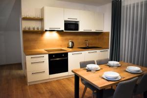 A kitchen or kitchenette at Apartmány Runi