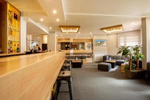 a lobby with couches and a bar in a building at Hotel Chantereyne in Cherbourg en Cotentin