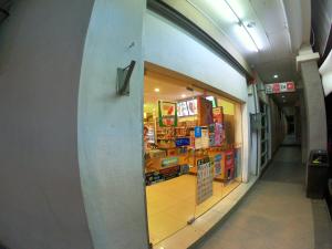 a surfboard leaning against the wall of a store at Sento Hotel in Keningau