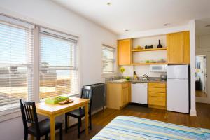 a kitchen with a table and a dining room table at Venice Suites in Los Angeles