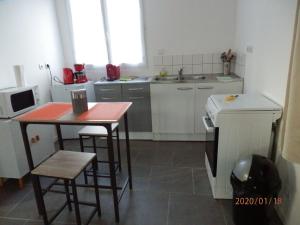 Linguizzettaにあるcorse locationの小さなキッチン(赤いテーブルと椅子付)