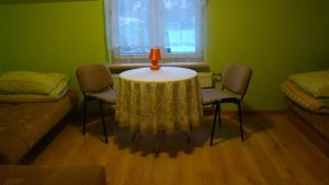 a room with a table and chairs and a window at Gospodarstwo agro Nad Kamienną in Bałtów +7 photos