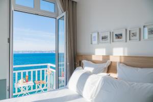 a bedroom with a bed with a view of the ocean at Les Bords De Mer in Marseille