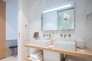 a bathroom with two sinks and a mirror at Les Bords De Mer in Marseille