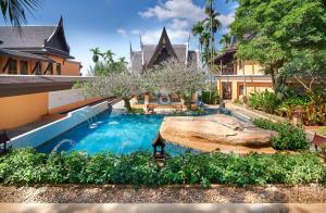 a swimming pool in front of a house at Amari Vogue Krabi in Tab Kaek Beach