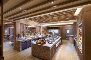 a large room with a bar with a lot of food at Amari Vogue Krabi in Tab Kaek Beach