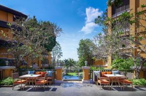 a patio at a hotel with tables and chairs at Amari Vogue Krabi in Tab Kaek Beach