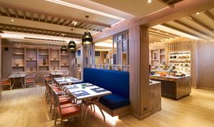 a restaurant with tables and chairs and a bar at Amari Vogue Krabi in Tab Kaek Beach