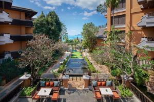 a view of the courtyard of a hotel with tables and chairs at Amari Vogue Krabi in Tab Kaek Beach