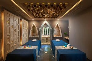 a room with two blue tables and a window at Amari Vogue Krabi in Tab Kaek Beach