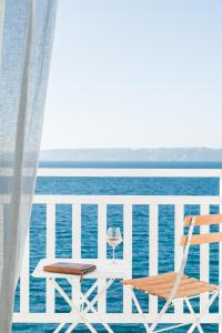 a table and a chair on a balcony overlooking the ocean at Les Bords De Mer in Marseille