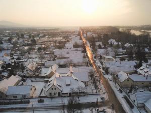 an aerial view of a town with snow covered roofs at Rácz Fogadó in Kisoroszi