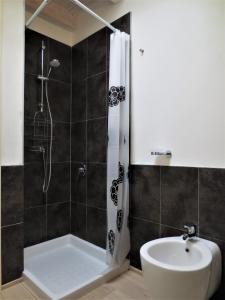 a bathroom with a shower and a toilet and a sink at Monolocale con giardino a 100m dal mare Punta Ala in Punta Ala