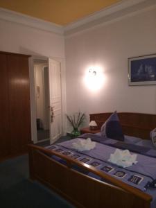 a bedroom with a bed with a blue comforter at Villa Hebel in Cuxhaven