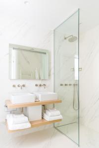 a bathroom with two sinks and a shower at Les Bords De Mer in Marseille +33 photos