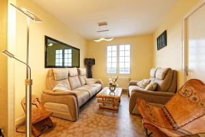 a living room with a couch and two chairs at Chambres d'hotes à Autun in Autun