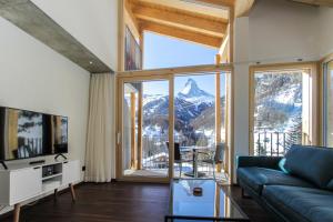 a living room with a view of a mountain at House Mojo in Zermatt