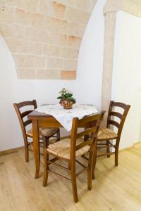 a wooden table with chairs and a plant on it at Don Pedro di Toledo in Monopoli