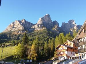 a mountain view of a town with houses and trees at Dolomites Holidays in Selva di Cadore