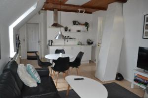 a living room with a couch and a table at AD Apartment in Køge