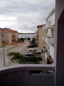 a view from a balcony of a street with cars at Apartments Teami in Povljana