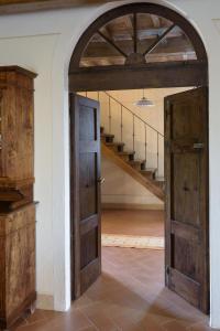 an open door in a room with a staircase at Agriturismo Cerreto in Pienza