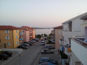 a view of a city street with cars parked at Apartments Teami in Povljana