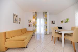 a living room with a couch and a table at Villa Sonja in Zadar