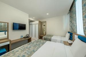Postel nebo postele na pokoji v ubytování Anelli Hotel