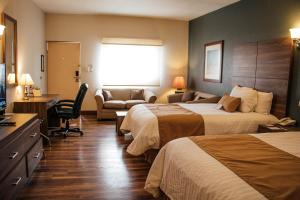 a hotel room with two beds and a couch at Best Western Cumbres Inn Cd. Cuauhtemoc in Cuauhtémoc