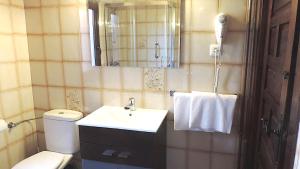 a bathroom with a sink and a toilet and a mirror at Duplex de encanto en Isla Playa in Arnuero +36 photos