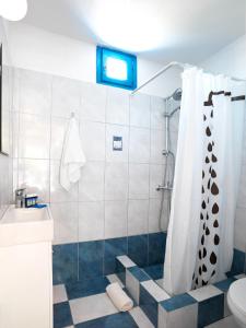 a bathroom with a shower and a toilet and a sink at Thalasea Kimolos - Θalasea - PS Rental in Kimolos +49 photos