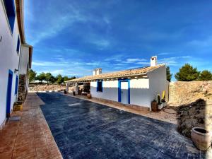 a building with a walkway next to a building at Cortijo Jamaro Boutique in Cehegín